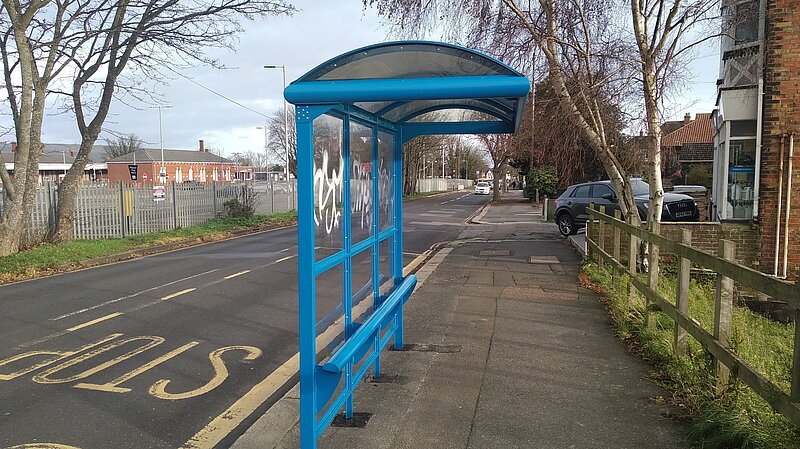 Bus stop and shelter with graffiti tag